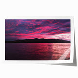 Scenic Maine landscape on rolled print, featuring lush greenery and tranquil water, in soft green and blue tones.