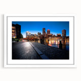 Abstract art print of Boston skyline in muted gray and blue tones, framed with a white mat, suitable for dining room decor.