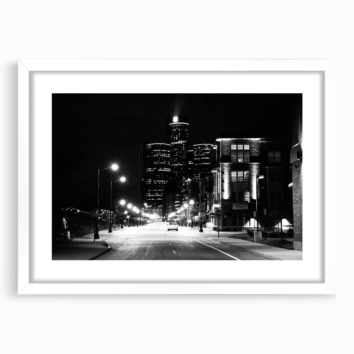 Abstract art print of Detroit skyline in muted gray and blue tones, framed with a white mat.