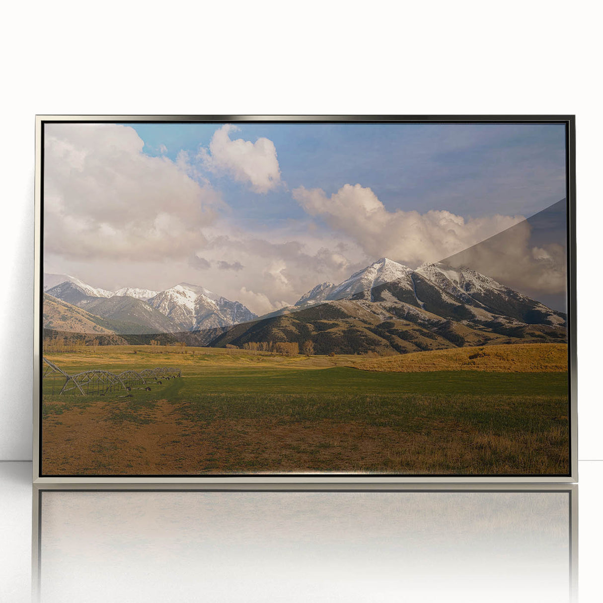 Mid-century modernist art depicting Montana scenery in muted earth tones on a silver-framed acrylic print.