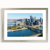 Textured abstract art print depicting a stylized Pittsburgh skyline in muted gray tones on a framed silver mat.