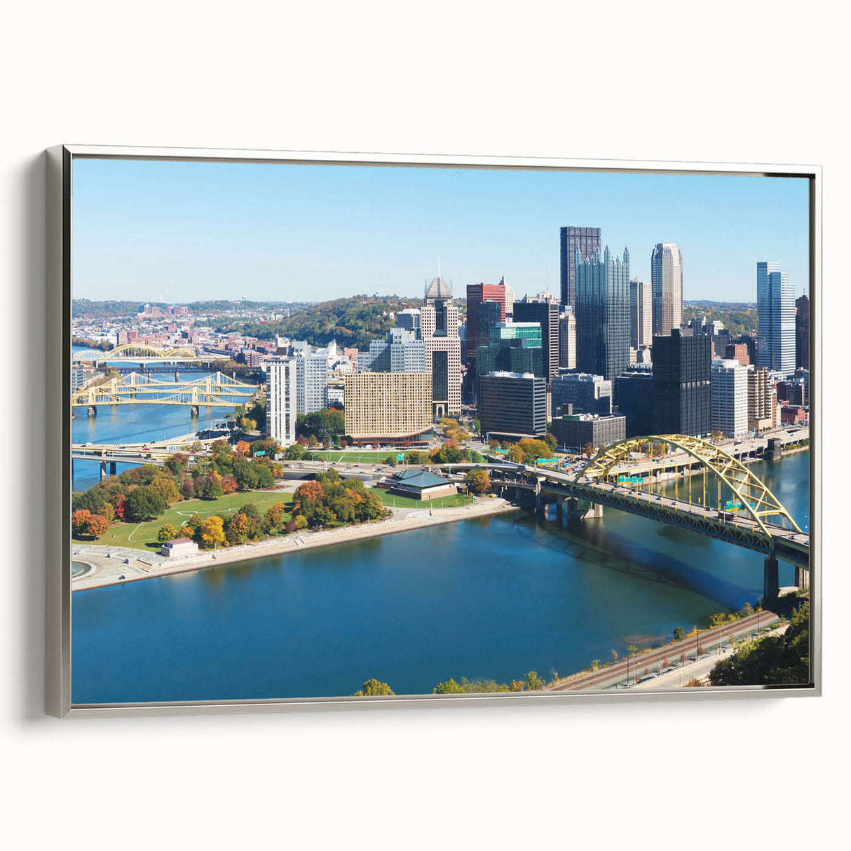 Framed canvas of a vintage-style Pittsburgh landscape in silver, black, and colorful tones, ideal for office decor.