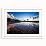 Abstract art print of Yellowstone scenery in muted green and blue tones, framed with a white mat.