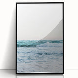 Large abstract wall art in vibrant orange and yellow, acrylic print in a black frame, suitable for modern living room decor.