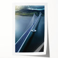 Landscape bridge rolled canvas print showcasing a serene river scene with lush greenery and a clear blue sky, packaged securely in a cardboard tube for easy transport and display.