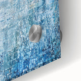 Close-up of an abstract design featuring colorful acrylic splatters on glass, showcasing vibrant hues of blue, orange, and yellow, perfect for modern decor.