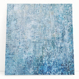 Abstract splatter art on stretched canvas showcasing vibrant colors of blue, yellow, and red, perfect for modern home decor or artistic statement pieces.