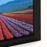 Close-up of textured black wall art featuring a colorful British Columbia scenery on a framed canvas.