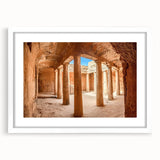 Textured art depicting abstract European scenery in muted earth tones on a framed white mat, suitable for bedroom decor.