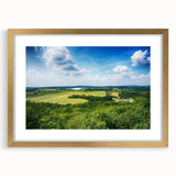 Abstract art print of a European cityscape in muted gold and gray tones on a framed canvas.