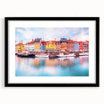 Colorful abstract art print of a European scenery in vibrant hues, framed in black, ideal for living room decor.