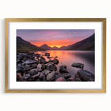 Abstract art print of Cumbria's landscape in muted green and blue tones, framed in gold, suitable for dining room decor.