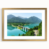Abstract art print of a Bavarian landscape in muted green and blue tones, framed in gold.