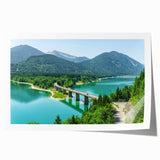 Scenic Bavaria landscape print on rolled canvas featuring a floral foreground in muted green and blue tones.