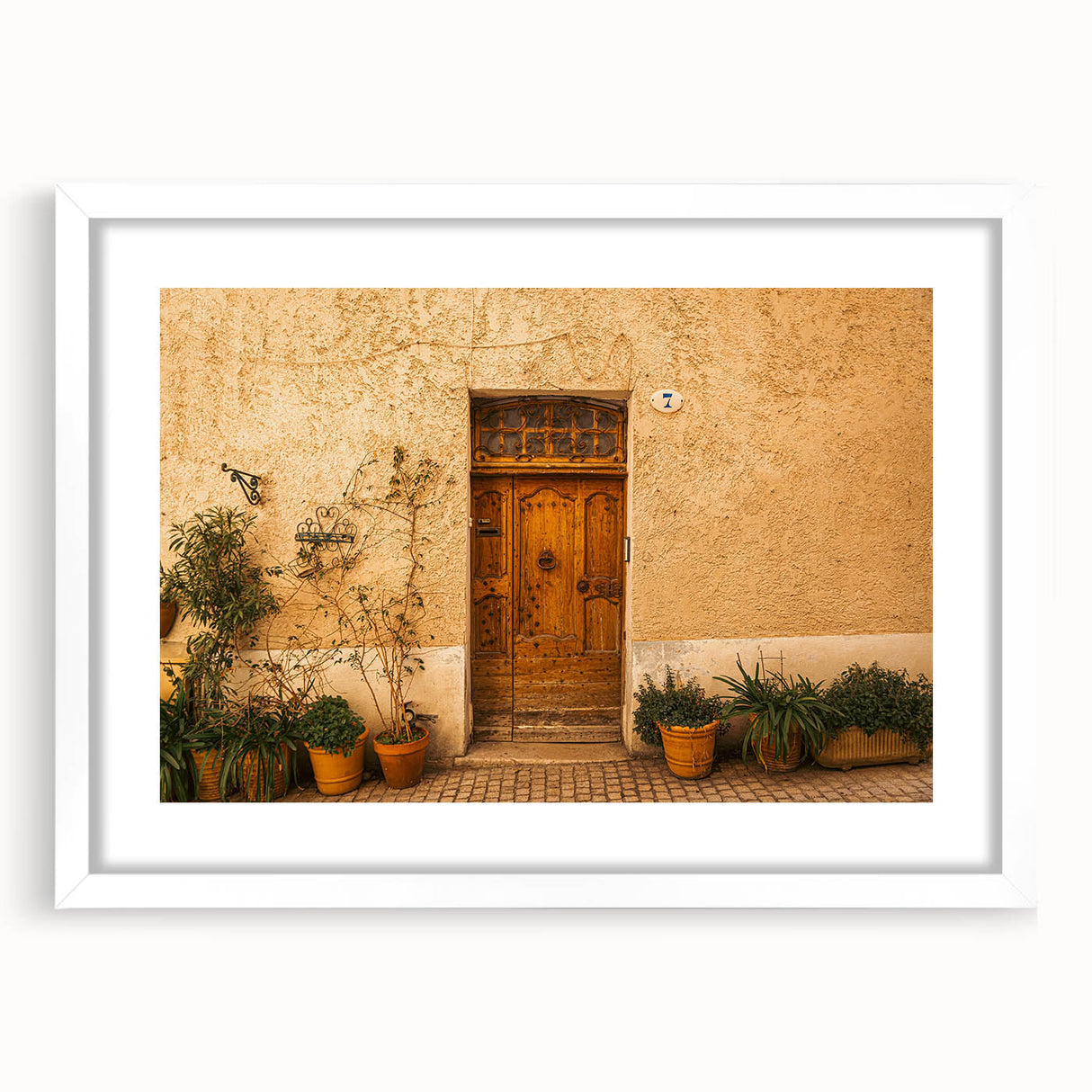 Textured art depicting abstract Tuscan landscape in muted earth tones on a framed white mat, suitable for bedroom decor.