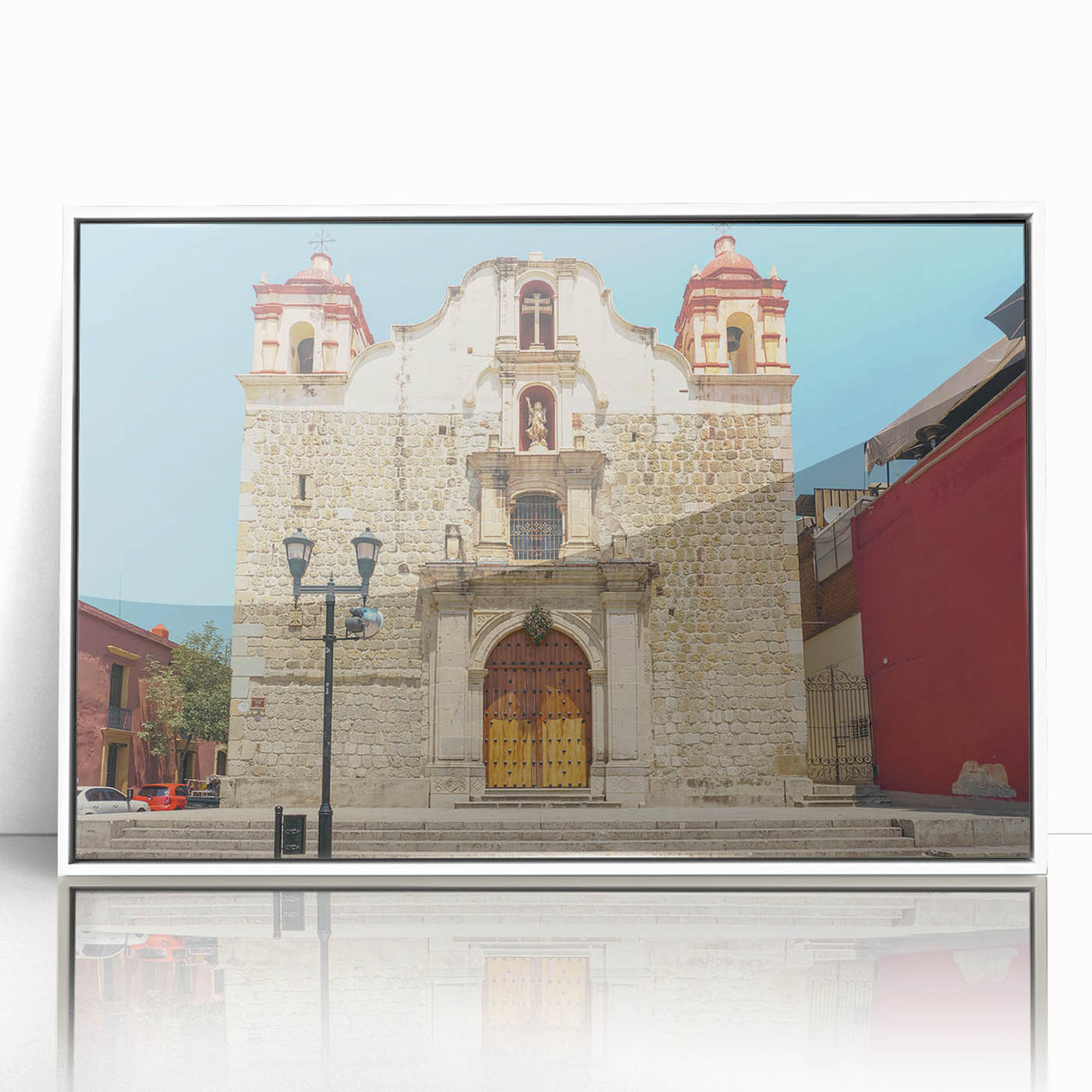 Art deco poster featuring a scenic view of Oaxaca, Mexico with vibrant colors, framed in white acrylic.