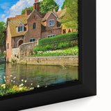 Black wall art featuring a textured, colorful abstract design on a framed canvas.