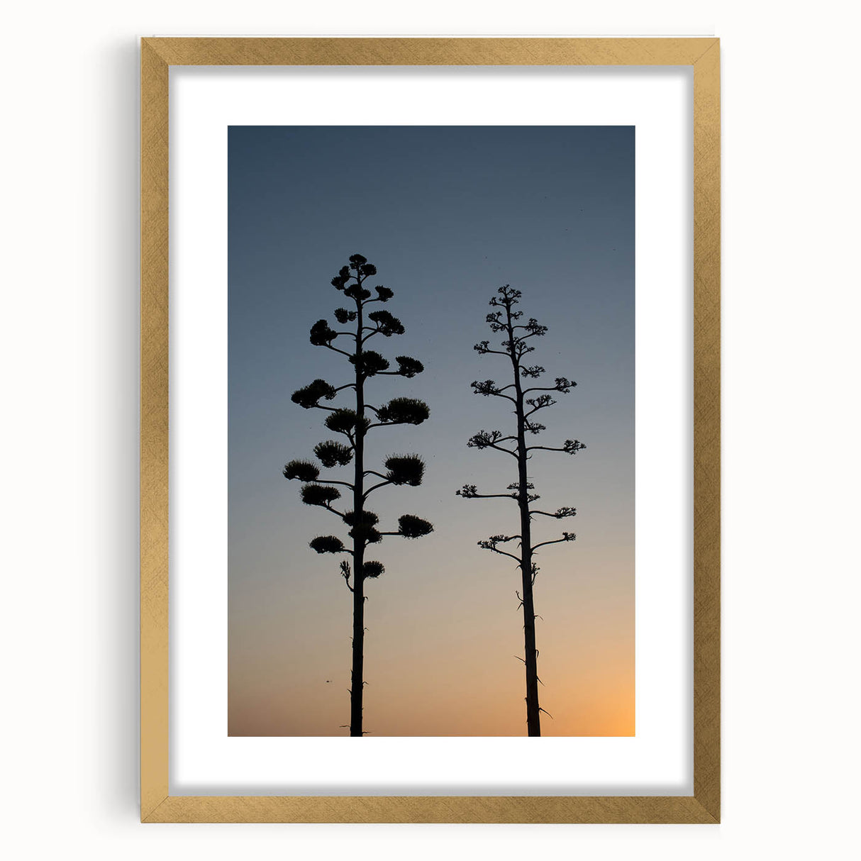 Extra large abstract art print of Los Angeles skyline in muted earth tones on a gold-framed canvas.