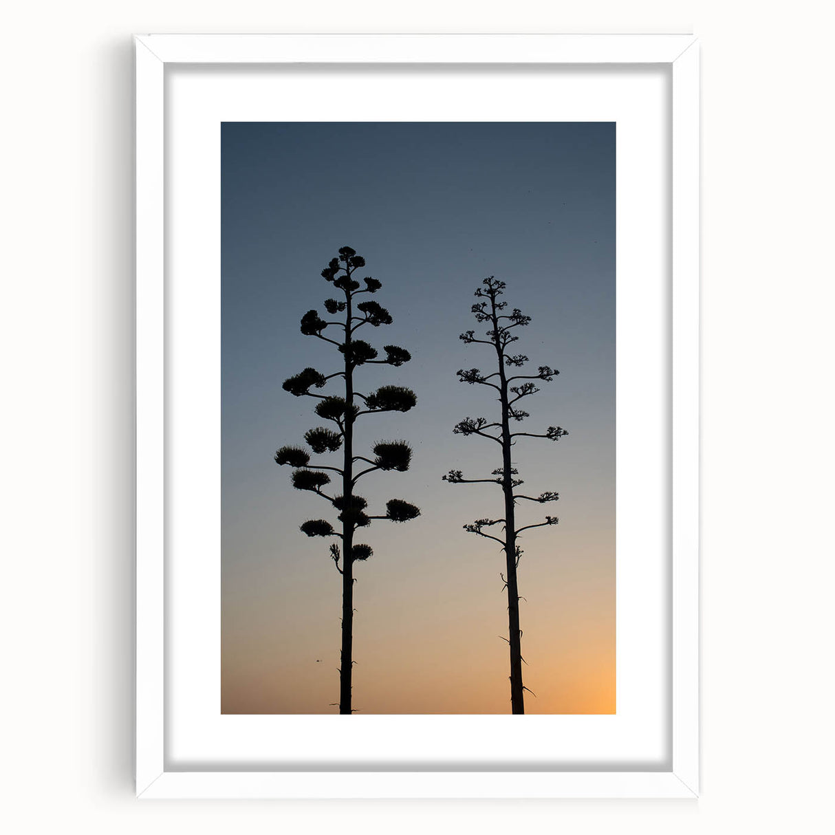 Abstract art print of Los Angeles skyline in muted gray and blue tones, framed in white.
