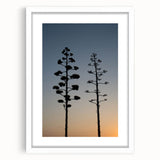Abstract art print of Los Angeles skyline in muted gray and blue tones, framed in white.