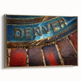 Framed canvas featuring a vintage-style landscape painting of Denver, Colorado, in muted gold and black tones.