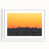 Abstract art print of Chicago skyline in muted gray and blue tones on a framed white mat, suitable for dining room decor.