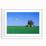 Abstract art print of a Kentucky landscape in muted green and blue tones, framed with a white mat.