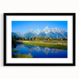 Colorful abstract art print of the Grand Tetons in textured style, set in a large black frame.