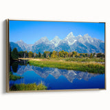 Framed canvas depicting the Grand Tetons in Wyoming with a vintage poster art style, featuring gold and black tones.