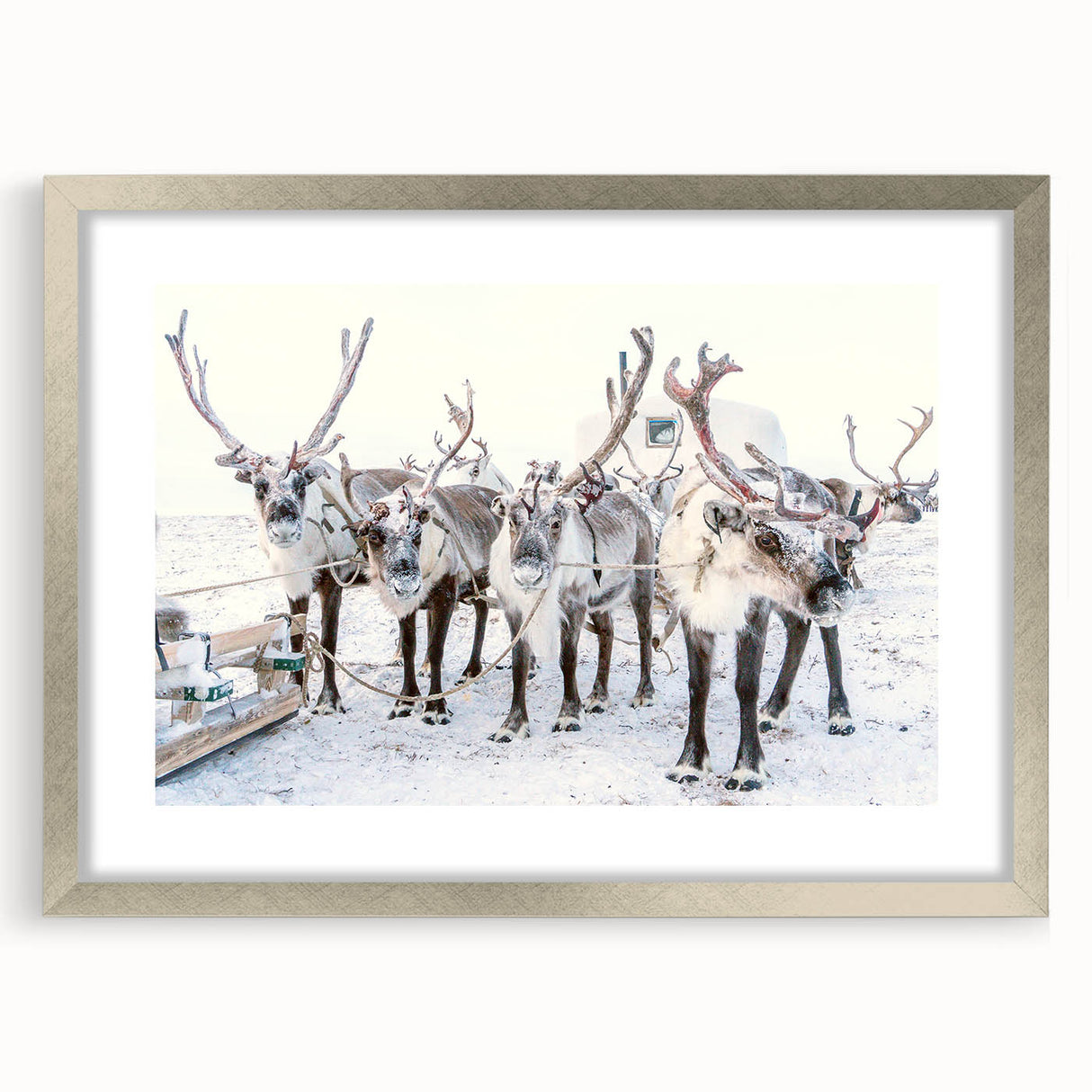 Textured art depicting an abstract winter scene in muted blue and white tones on a framed silver mat.