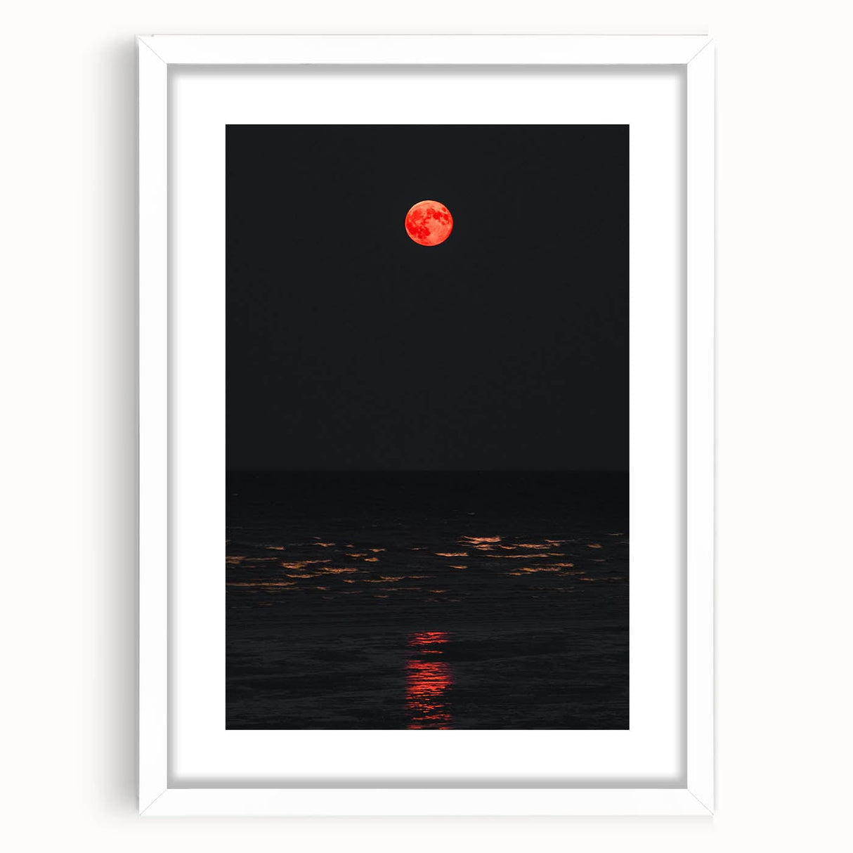 Abstract art print depicting autumnal trees in orange and red tones on a white framed canvas.