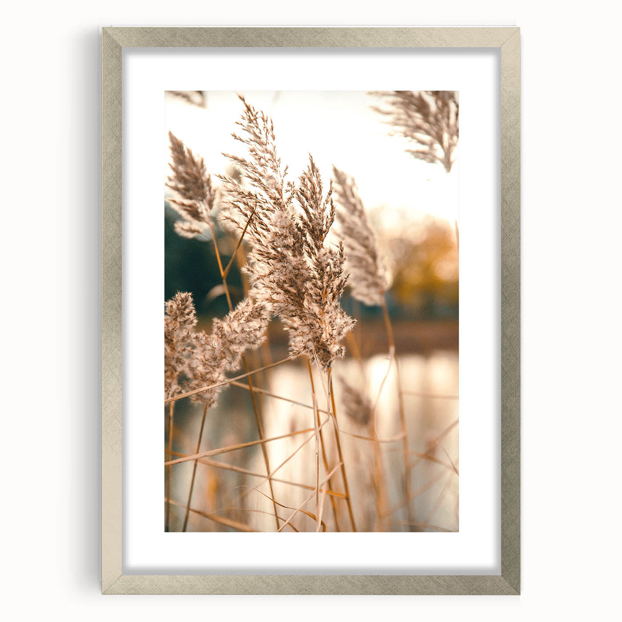 Textured abstract art print in warm orange and yellow hues on a silver-framed canvas, ideal for bedroom ambiance.