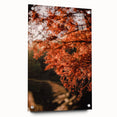 Large abstract wall art depicting autumnal trees on acrylic glass, in warm orange and red tones.