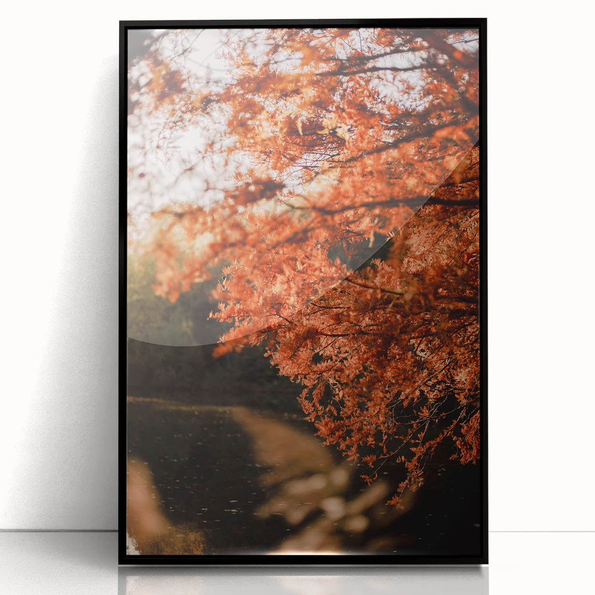 Large abstract wall art depicting autumnal trees in warm orange and red tones on a black acrylic framed canvas.