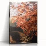 Mid-century modernist art depicting autumn trees in orange and brown tones on a silver-framed acrylic print.