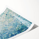 Abstract art print showcasing vibrant splatters of blue, orange, and yellow on a textured background, rolled and ready for display, perfect for modern home décor.