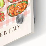 Close-up of large abstract wall art featuring various food dishes in vibrant colors on acrylic glass.