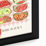 Close-up of black wall art featuring a variety of colorful, textured food dishes on a framed canvas.