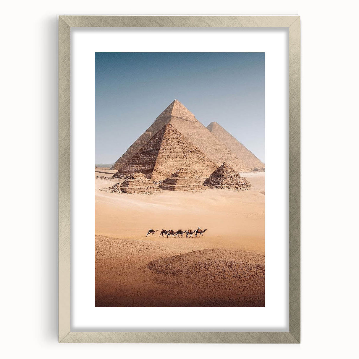 Abstract art print of Egyptian scenery in muted earth tones on a silver-framed mat, suitable for dining room decor.