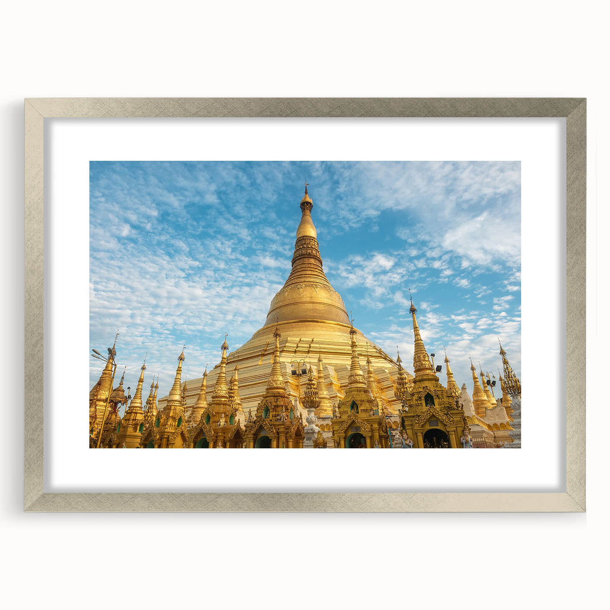 Textured abstract art print of a Myanmar landscape in muted earth tones, framed in silver, suitable for bedroom ambiance.
