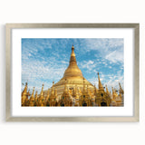 Textured abstract art print of a Myanmar landscape in muted earth tones, framed in silver, suitable for bedroom ambiance.