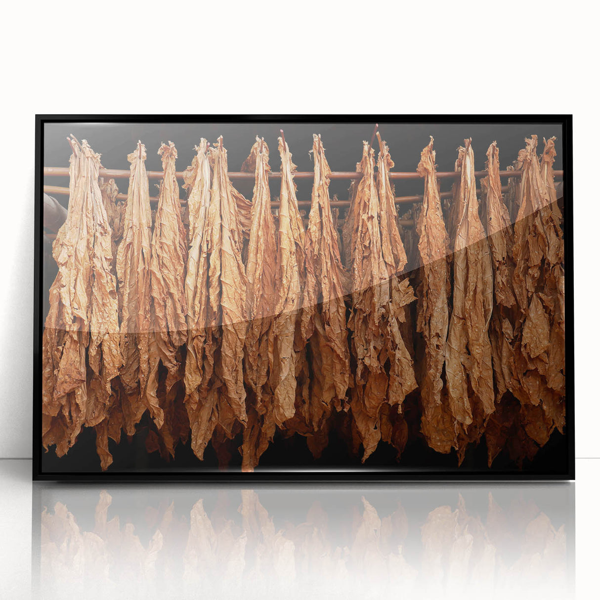 Large abstract wall art depicting a Caribbean scenery in muted blues and greens, framed in black acrylic.