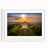 Textured art print of an abstract European scenery in muted earth tones on a framed white mat, suitable for bedroom decor.