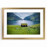 Abstract art print featuring soft blue and white hues, in a gold frame with mat.