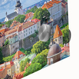 Large abstract wall art of a European cityscape in muted gray and blue tones on acrylic glass.