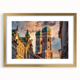 Abstract art print of a European scenery in muted gold and blue tones, framed with a gold mat.