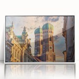 Mid-century modernist art depicting a European cityscape in muted gray and blue tones on a framed acrylic print.