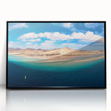 Large abstract wall art depicting a stylized European scenery in muted earth tones, framed in black acrylic.