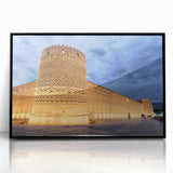 Large abstract wall art depicting a Middle-Eastern scenery in muted earth tones, framed in black acrylic.