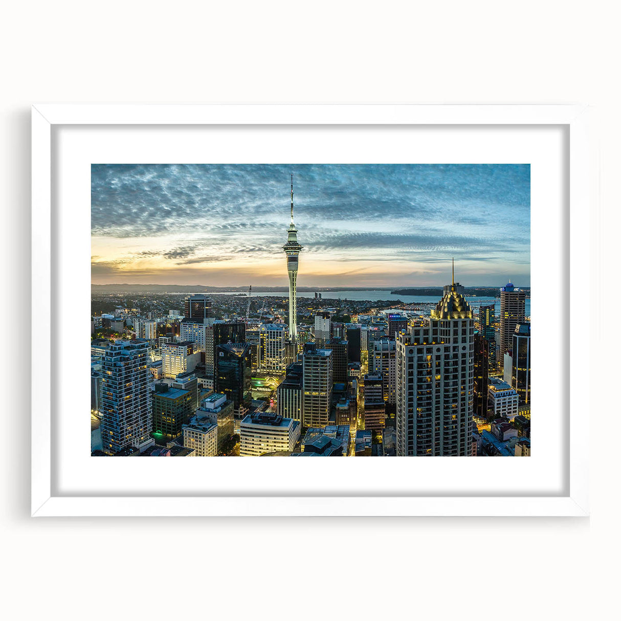 Abstract art print of Auckland skyline in muted blue tones on a white framed canvas.